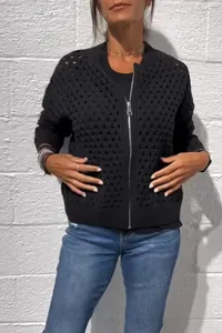 Detailed macro view of black hollow-out knitted zip-up cardigan jacket for women