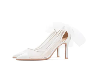 Elegant white mesh polka dot bridal stiletto heels featuring a large silk organza bow