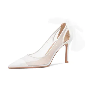 Elegant white pointed-toe high heels with polka dot mesh and oversized rear bow