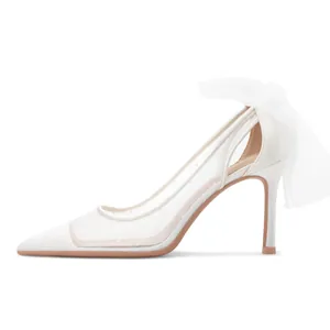 Elegant white pointed toe stiletto heels with polka dot mesh and a decorative rear mesh bow