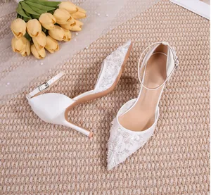 Vue détaillée d'élégantes chaussures de mariage en dentelle blanche avec bride