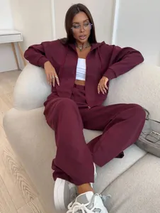 Stylish burgundy two-piece tracksuit set with zip-up hoodie and sweatpants worn by model