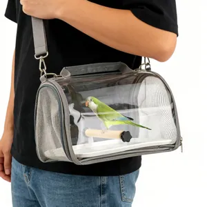 Detail of portable transparent bird carrier bag with wooden perch being carried
