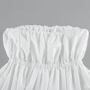 Close-up detail showing the smocked elastic waist and gathered fabric of a white tube top
