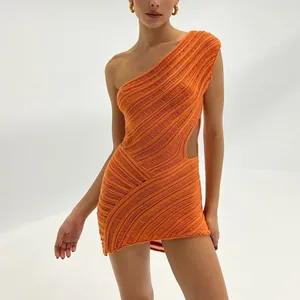 Detailed view of an orange one-shoulder knitted mini dress with unique cut-out design.