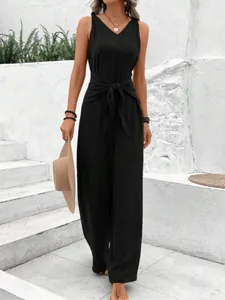 Detailed view of an elegant black sleeveless V-neck jumpsuit with stylish waist knot detail