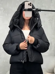 Trendy women's black hooded puffer jacket, short length street style padded coat.