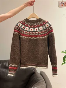 Vintage brown Fair Isle knit sweater with colorful patterns on a wooden hanger.
