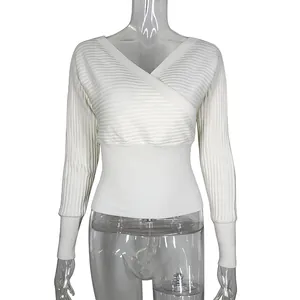 Close-up view of a white V-neck wrap knit sweater featuring ribbed batwing sleeves design