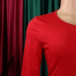 Close-up of red bodycon dress featuring refined shoulder seams and elegant round neck.