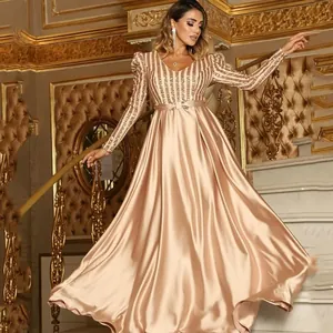 Detailed view of champagne V-neck evening gown with sequined stripes and satin skirt
