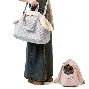 Grey and pink quilted pet carrier bags for cats shown in use on a clean white background