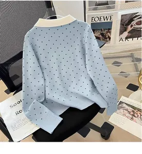 Close-up detail of a light blue polka dot knit cardigan featuring a classic polo collar design