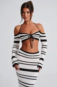 Chic black and white striped crochet two-piece set featuring halter top and midi skirt.