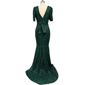 Back view detail of dark green sequined evening gown with bow and lantern sleeves