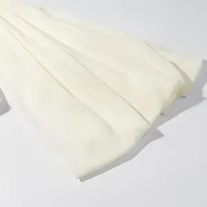 Detailed view showing the smooth texture and drape of the white flared sleeve set.