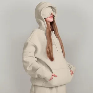 Detail view of oversized beige hoodie with a unique built-in eye mask design