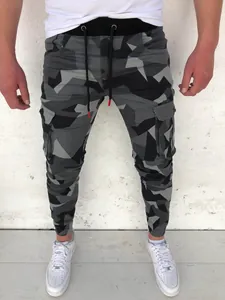 Close-up view of men's geometric camouflage cargo pants with drawstring and pockets