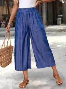 Stylish blue wide-leg cropped pants with side pockets and elastic waist for summer.