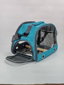 Detail view of portable bird carrier bag with wooden perch and transparent PVC side panels