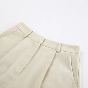 Macro detail view of khaki cotton linen shorts featuring waist belt loops and side pockets