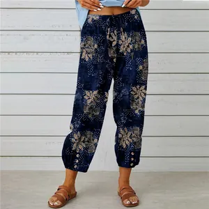 Detail view of high waist cotton linen trousers with retro floral print and drawstring