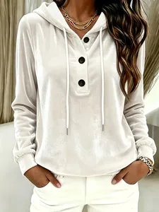 Detailed close-up of white crushed velvet hooded sweatshirt with black buttons and drawstring