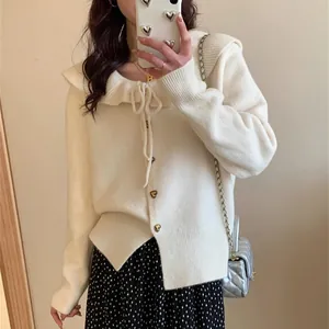 Detailed view of a cream-colored sailor collar knit cardigan with gold heart buttons
