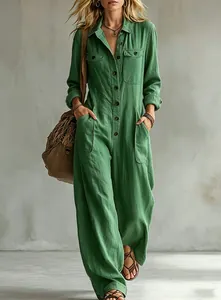 Close-up of relaxed green linen jumpsuit with long sleeves and wide-leg design