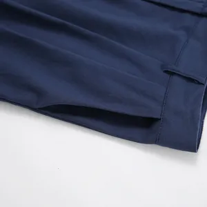 Macro view of navy blue cotton linen shorts showing side pocket and waistband details