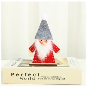 Cozy handmade felt Christmas gnome figurine on a wooden base for festive holiday home decor