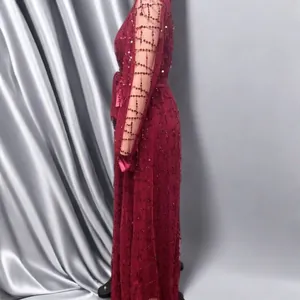 Side view of elegant burgundy mesh evening gown with sequin lattice pattern