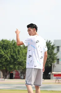 Modello indossa pantaloncini da basket in mesh grigio traspirante in un parco