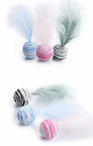 Detailed macro view of macaron cat toy balls with marble patterns and soft feathers