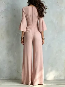 Elegant back view of a French style mauve pink wide-leg jumpsuit with bell sleeves and belt