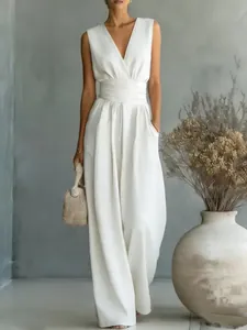 Full view of elegant white V-neck jumpsuit with waist cinching and wide leg design