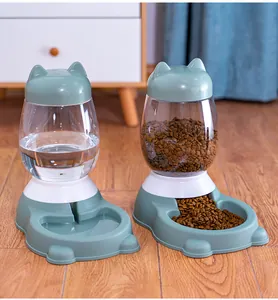 Detail view of gravity-fed automatic pet food and water dispensers in a home setting