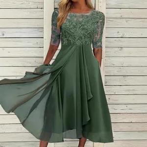 Close-up of green chiffon bridesmaid dress with elegant lace bodice embroidery details