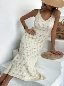 Elegant white hollow-out knit maxi dress with leaf pattern for summer beach vacation.