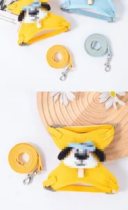 Detailed view of yellow cartoon dog harness with matching leash for small pets.