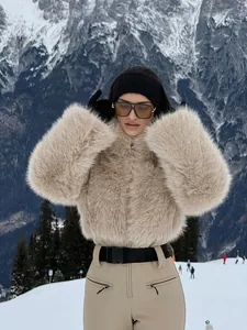Detail view of a light khaki slim-fit one-piece ski suit in a snowy mountain landscape.