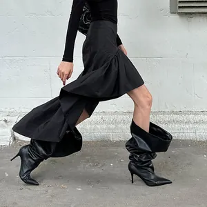 Detailed shot of a black asymmetrical ruffled skirt for a stylish commuter look.