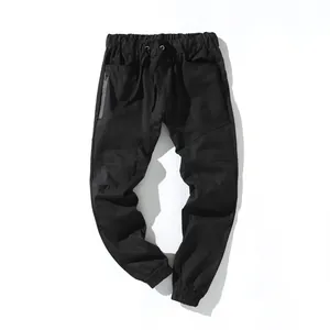 Detalle de pantalones cargo negros para hombre con cintura elástica y múltiples bolsillos.