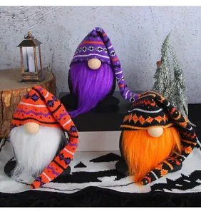 Three handmade Halloween gnomes with long knitted hats and plush beards.