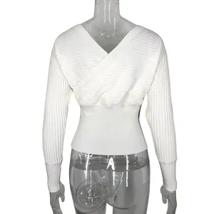 Back view of white V-neck knit sweater with crossover design and batwing sleeves