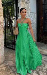 Elegant green halter neck pleated maxi dress with waist cutout design worn by a model