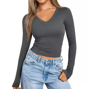 Women's slim-fit dark grey V-neck long-sleeve top shown in a clean studio setting