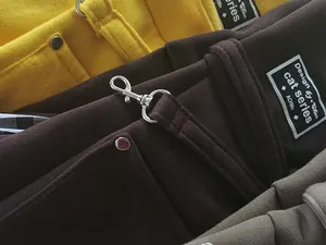 High-definition close-up of a canvas pet carrier bag with silver metal hardware