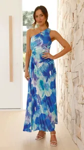 Floral one-shoulder maxi dress with side cutout and pleated detailing on model.