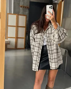 Detail of oversized vintage plaid shirt for women in a street style mirror selfie